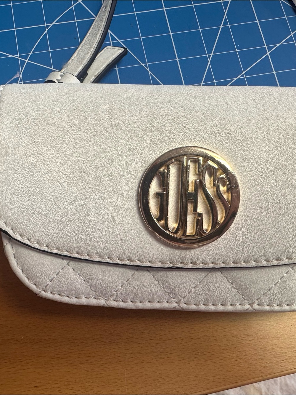 GUESS Cream Quilted belt bag with Gold Logo Medallion